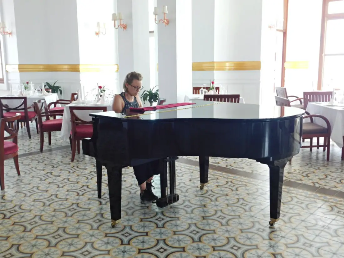 Playing piano at the Bokor Palace Hotel near Kampot