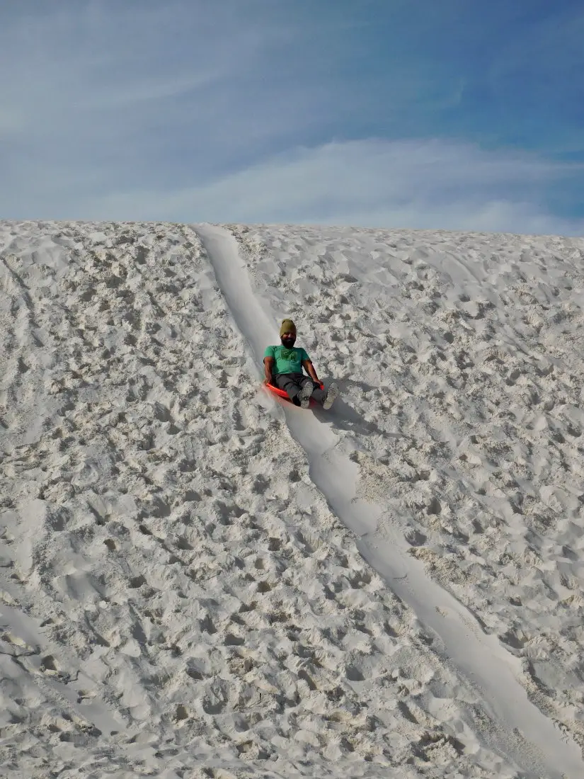 Sledding down the dunes at White Sands National Monument in New Mexico