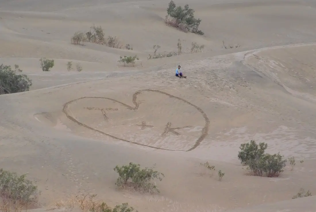 Writing in the sand dunes in Death Valley National Park