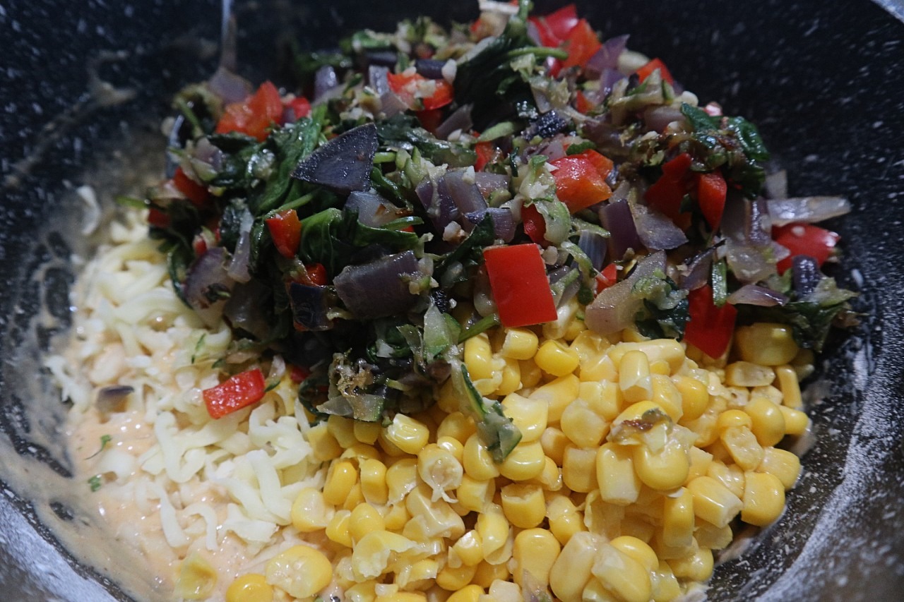 Mixing ingredients for corn and zucchini fritters recipe