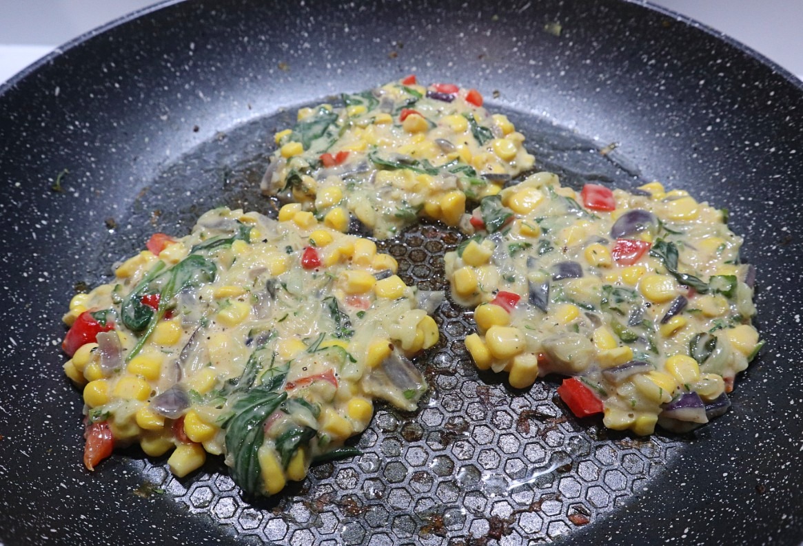 Zucchini and corn fritters frying